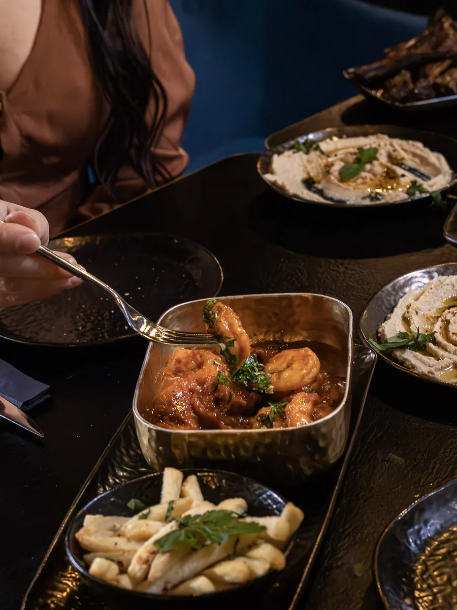Sharing dishes being served at the table